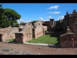 06603 ostia - regio iv - insula v - terme delle sei colonne (iv,v,10-11) - decumanus maximus - laeden am westende - re - schola del traiano (iv,v,15) and domus (iv,v,16).jpg